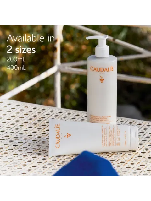 Caudalie lotion bottles on a patterned table, available in 200mL and 400mL sizes.