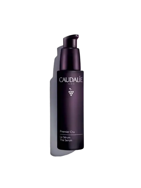 Dark purple bottle of Caudalie Premier Cru Le Sérum with pump dispenser.