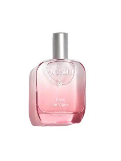 Caudalie Rose de Vigne Eau Fraîche fragrance in a pink glass bottle with a silver cap.