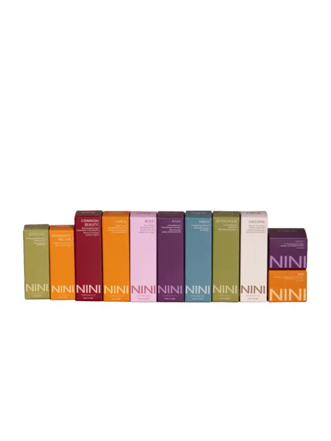 Colourful NINI Organics skincare boxes in a row, each with different product names.