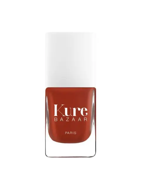 Kure Bazaar nail polish bottle with white cap and red colour.