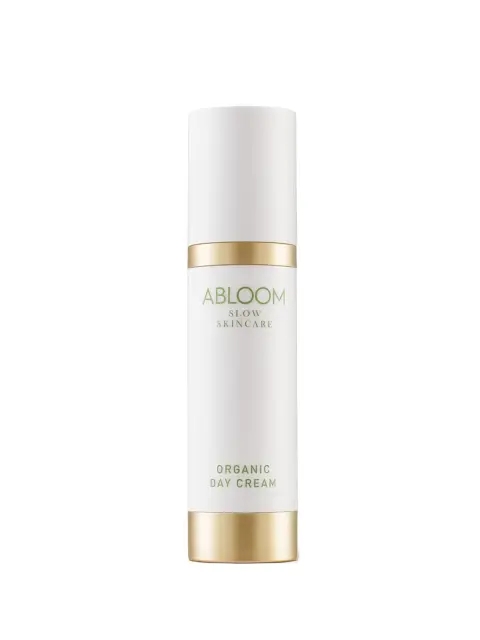 White bottle of Abloom Organic Day Cream with gold accents.