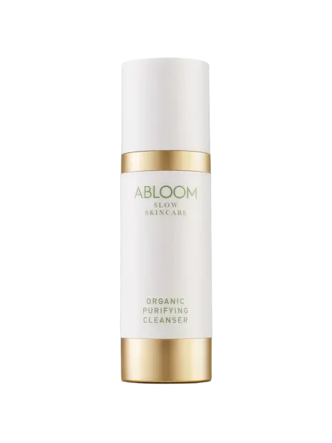 Abloom Slow Skincare Organic Purifying Cleanser in a white and gold bottle.