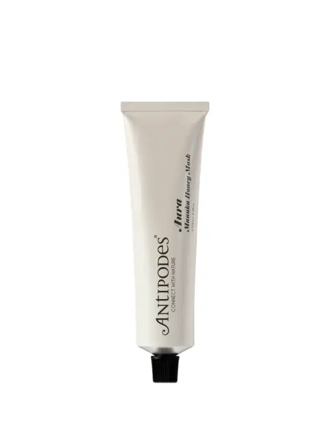 Antipodes Aura Manuka Honey Mask tube with black cap on white background.