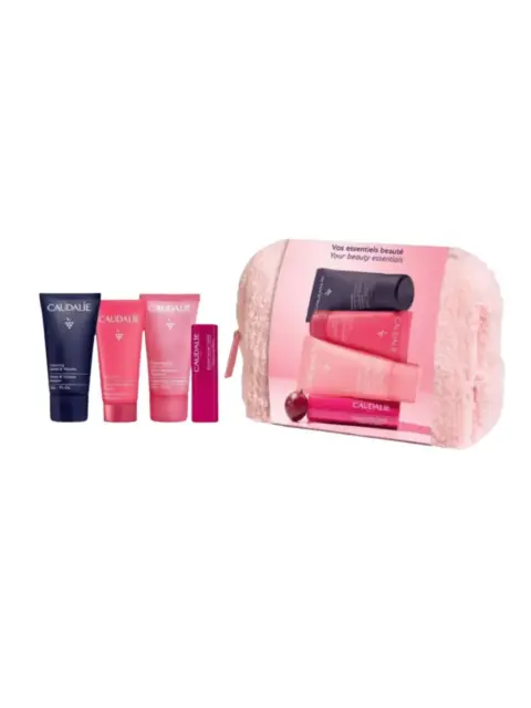 Skincare set with four Caudalie products and a pink pouch.