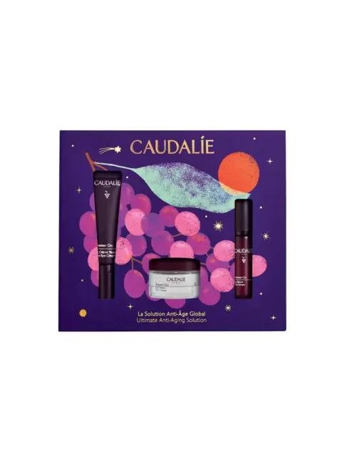 Caudalie skincare set with eye cream, serum, and cream on a purple grape-themed box.
