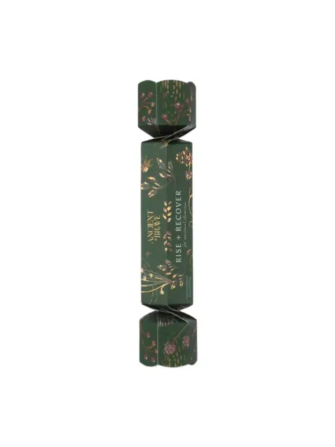 Green cracker with floral design, text "Moment of Tranquillity" and "Rise + Recover".