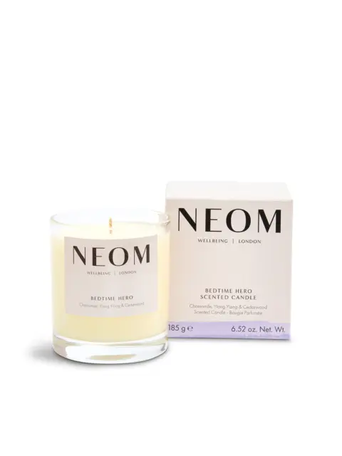 NEOM Bedtime Hero candle, chamomile, ylang ylang, cedarwood, 185g, next to its box.