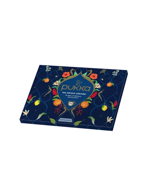 Pukka tea advent calendar box with floral and fruit design on a dark background.