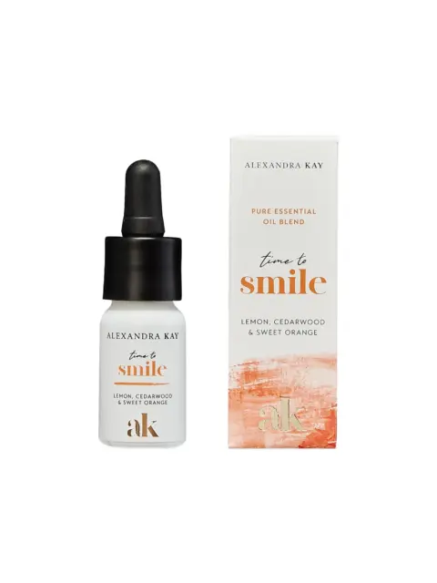 Essential oil bottle and box, "time to smile", lemon, cedarwood, sweet orange.