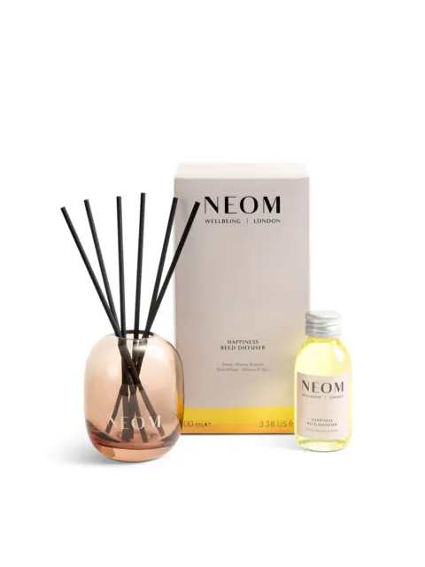 NEOM Happiness reed diffuser with box and refill bottle.