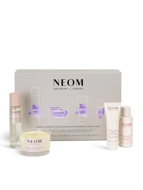 NEOM Wellbeing Discovery Collection with mist, candle, body butter, bath foam, and packaging.