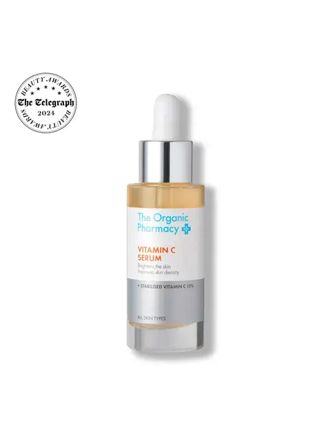 The Organic Pharmacy Vitamin C Serum bottle with dropper and award badge.
