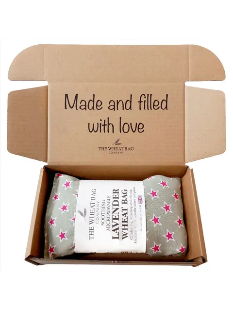 Open box with lavender wheat bag, pink stars, text: "Made and filled with love".
