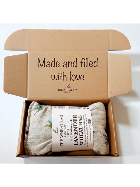 Open box with a lavender wheat bag inside. Text: "Made and filled with love".