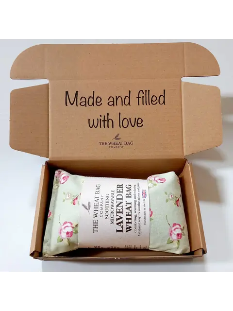 Open box with lavender wheat bag, floral pattern, text: "Made and filled with love".