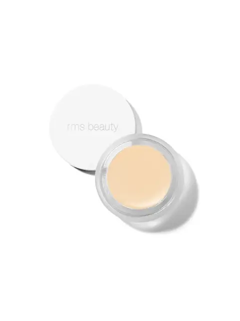 Open jar of beige cream with "rms beauty" on the lid, viewed from above.