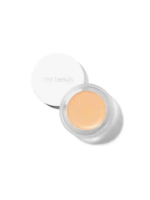 Open jar of rms beauty concealer with lid beside it.