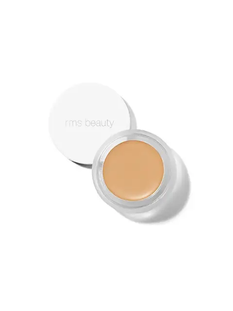 Open jar of beige cream with "rms beauty" on the lid.