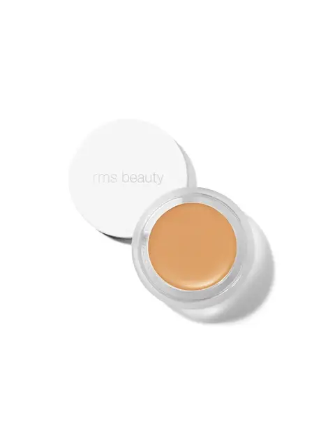 Open jar of RMS Beauty concealer with white lid beside it.