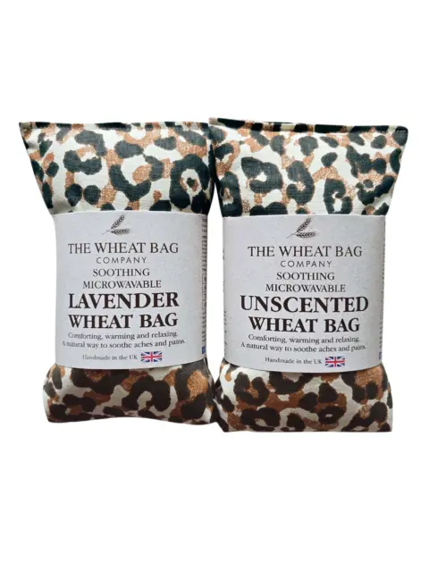 Two leopard print wheat bags, one lavender, one unscented, labelled for soothing and microwavable use.
