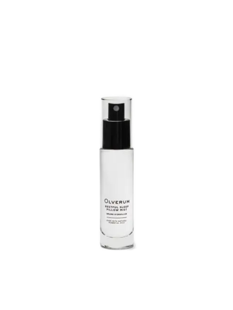 Clear bottle of Olverum Restful Sleep Pillow Mist with black spray top.