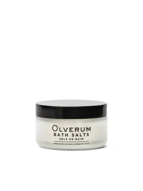 Olverum Bath Salts jar with black lid, labelled with essential oils.