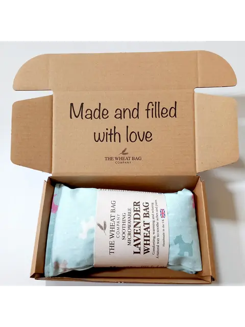 Open box with lavender wheat bag and text "Made and filled with love".