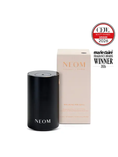 NEOM Wellbeing Pod Mini+ diffuser with award badges for 2026.