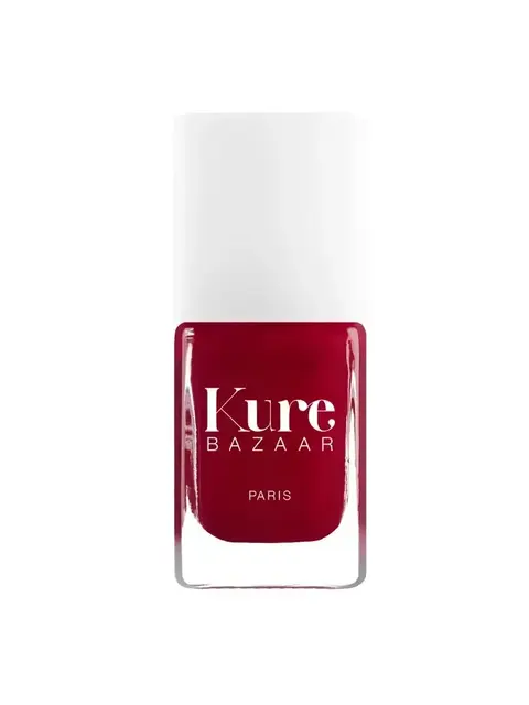 Red Kure Bazaar nail polish bottle with white cap.