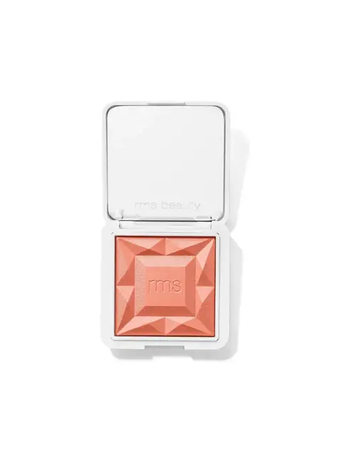 Open compact with peach blush, embossed "rms", in white case.