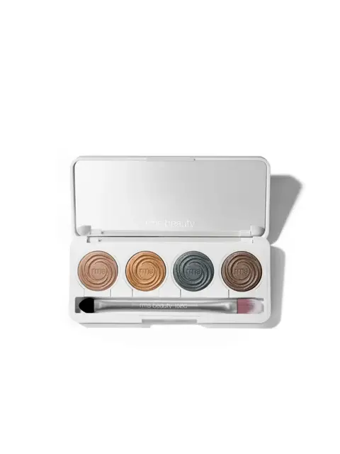 Makeup palette with four eyeshadows and a brush in a white case.