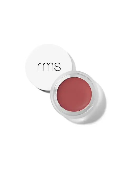 Open pot of red cream with white lid displaying "rms" text.