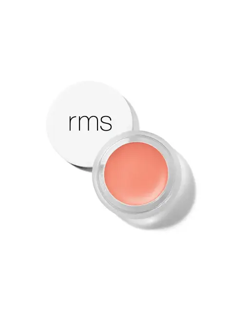 Open jar of peach-coloured cream with "rms" on the white lid.
