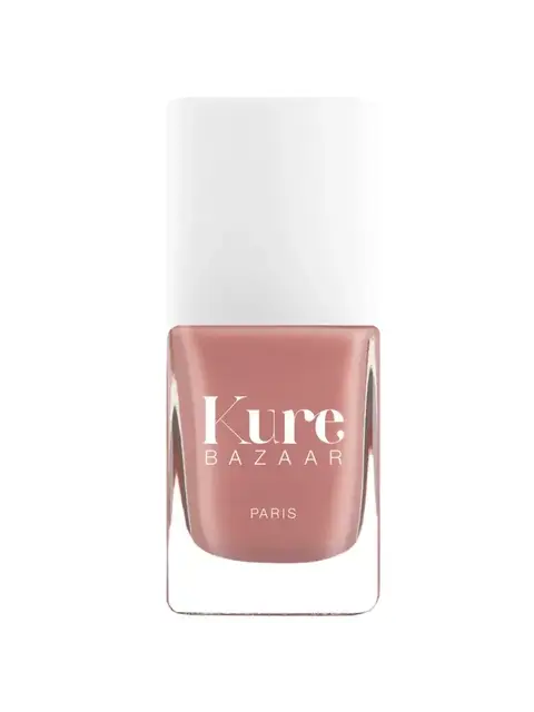 Kure Bazaar nail polish bottle with white cap, pink shade, text "Kure Bazaar Paris".
