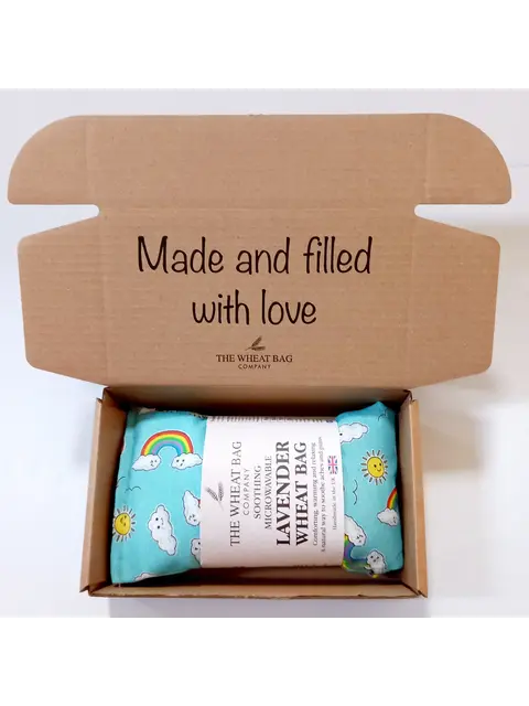 Open box with a lavender wheat bag inside. Text on lid: "Made and filled with love".
