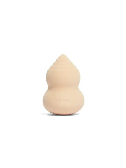 Beige makeup sponge with "rms beauty" embossed, shaped like a gourd.