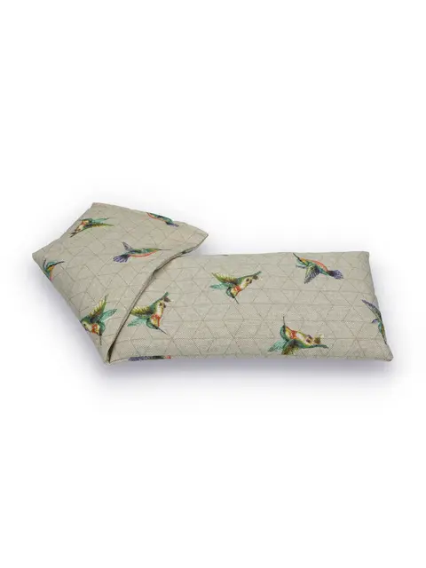 Beige eye pillow with colourful bird pattern.