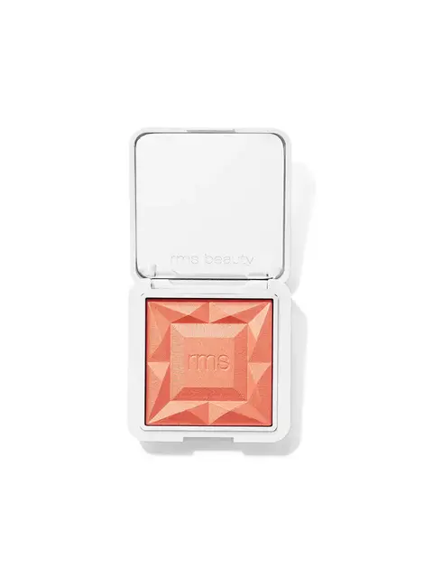 Open compact with peach blush, geometric pattern, and "rms" embossed on the surface.