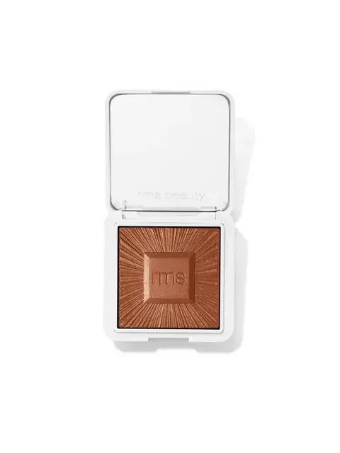 Open compact with bronze powder, "rms beauty" embossed on lid and powder.