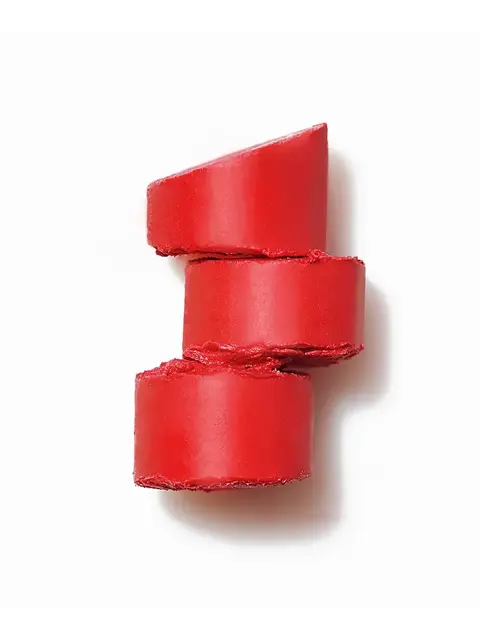Three stacked red lipstick slices on a white background.