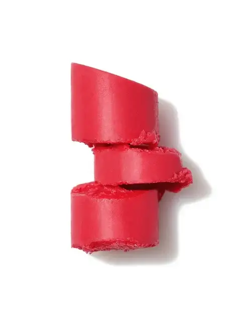 Three stacked pieces of red lipstick on a white background.
