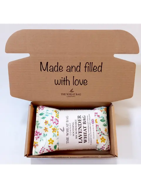 Open box with a floral lavender wheat bag and text "Made and filled with love".