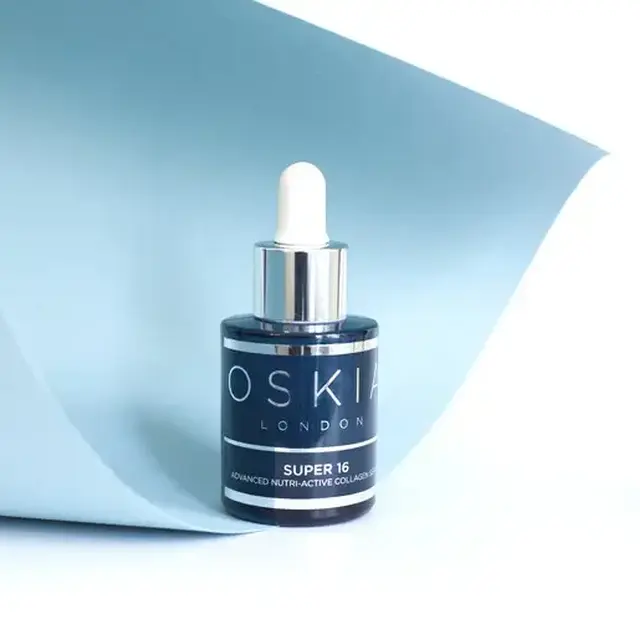 Oskia London Super 16 serum bottle with dropper on light blue background.