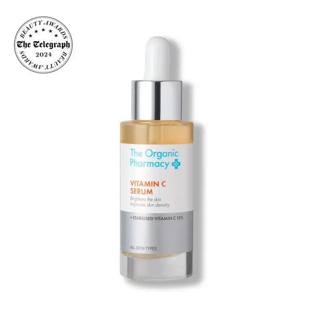 The Organic Pharmacy Vitamin C Serum bottle with dropper and award badge.