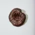 Brown reishi mushroom on a white background.