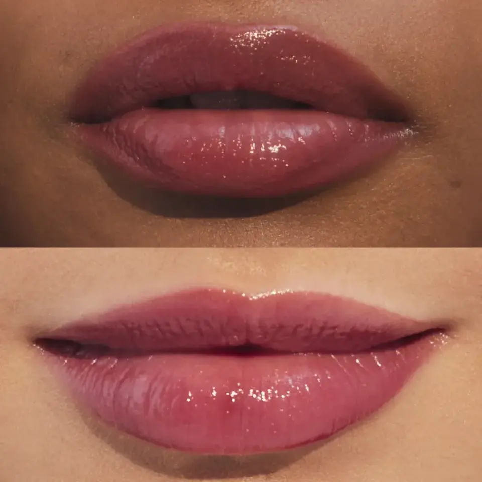Two sets of lips with glossy pink lipstick, top darker skin, bottom lighter skin.