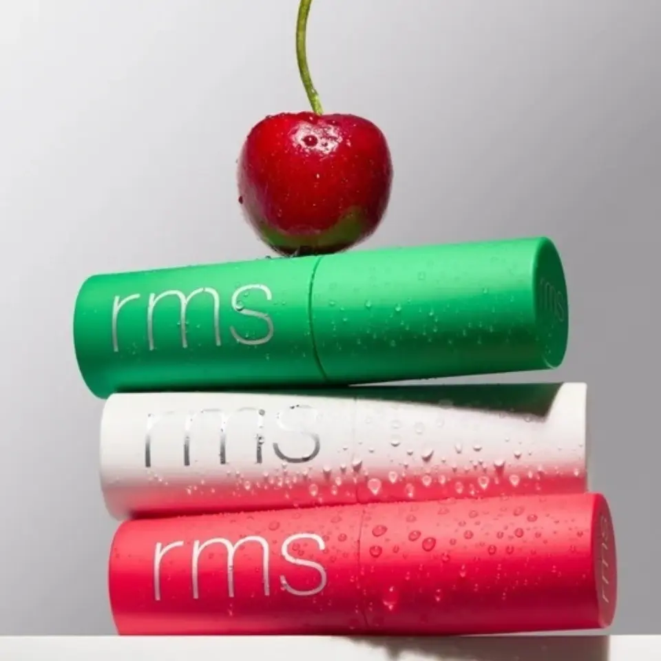 Three rms lip balms stacked with a cherry on top.