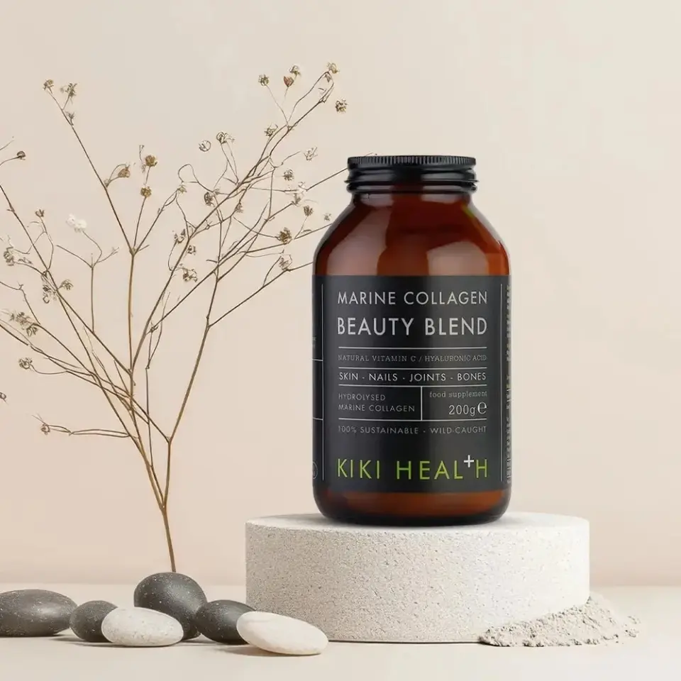 Marine Collagen Beauty Blend jar on a stone platform with pebbles and dried flowers.