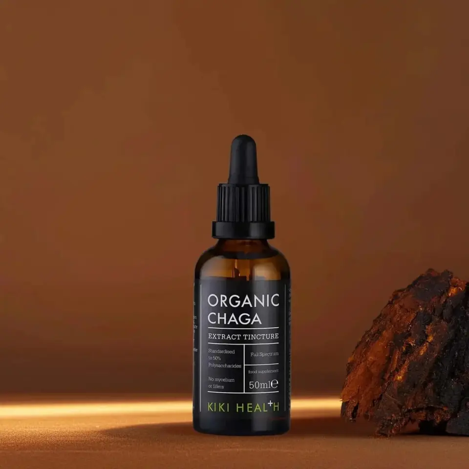 Brown bottle of Organic Chaga extract tincture, 50ml, next to chaga mushroom piece.
